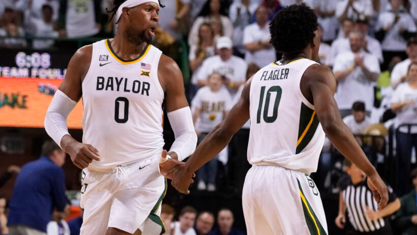 Baylor forward Flo Thamba high-fiving teammate Adam Flagler