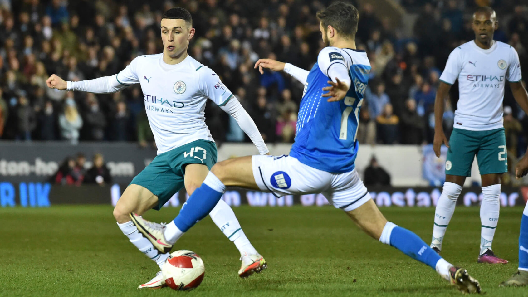 Manchester City's Phil Foden fighting for the ball during a soccer match.