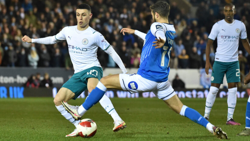 Manchester City's Phil Foden fighting for the ball during a soccer match.