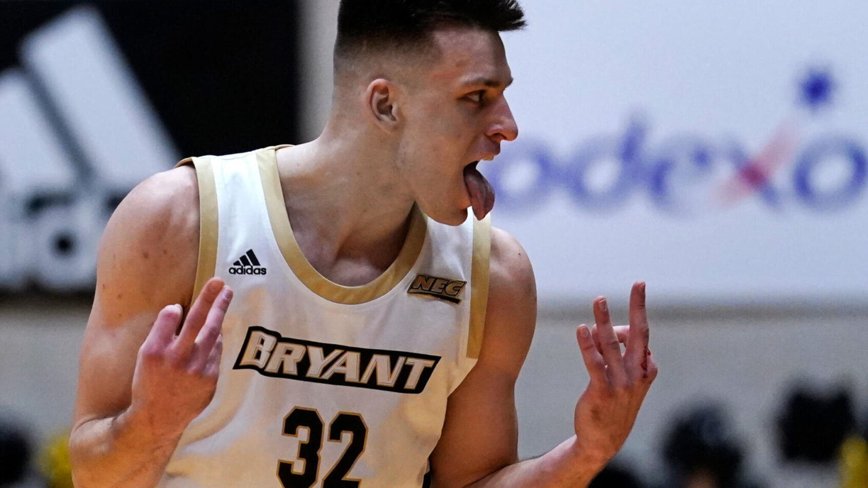 Bryant guard Peter Kiss celebrates after making a three