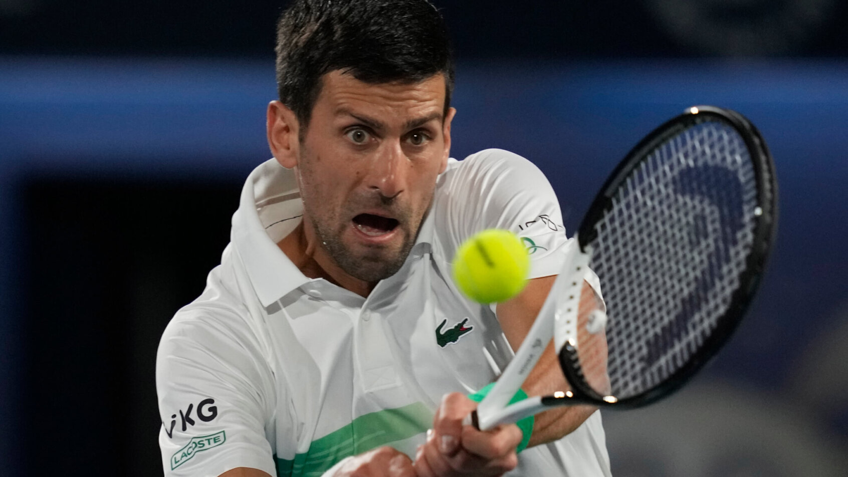 Novak Djokovic hitting a return during a tennis match.
