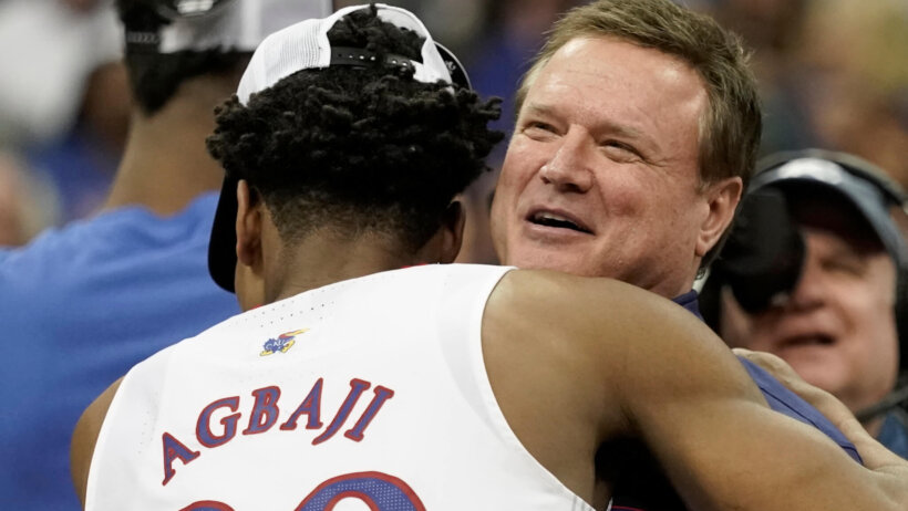 Kansas head coach Bill Self abnd guard Ochai Agbaji hugging
