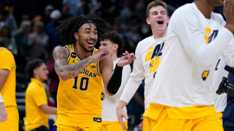 Michigan guard Frankie Collins celebrating a win over Colorado State with his teammates