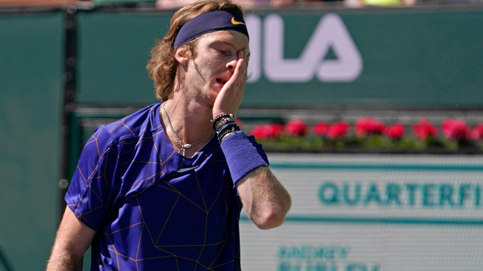 Andrey Rublev covering his face after losing a point