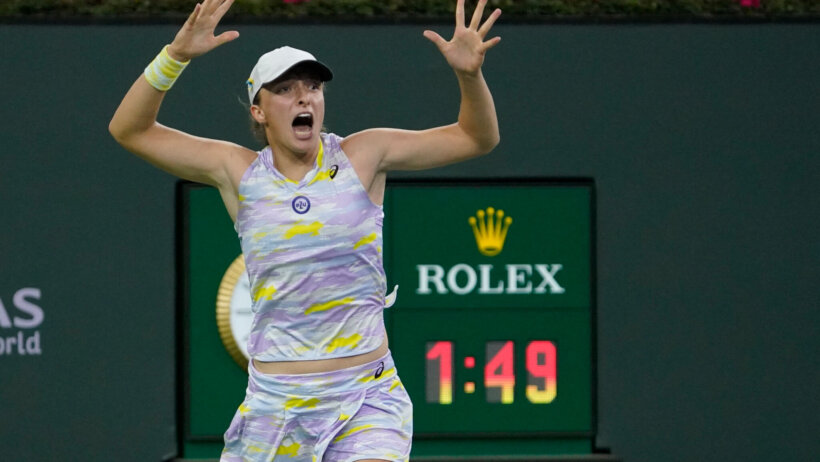 Iga Swiatek reacts to winning