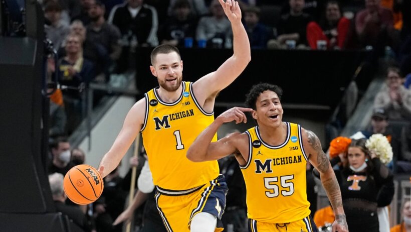 Michigan's Hunter Dickinson and Eli Brooks celebrate a win