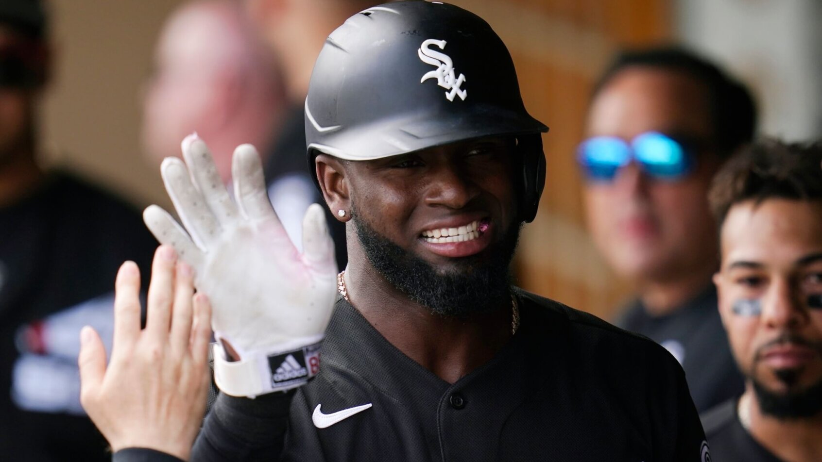 Luis Robert dugout high fives