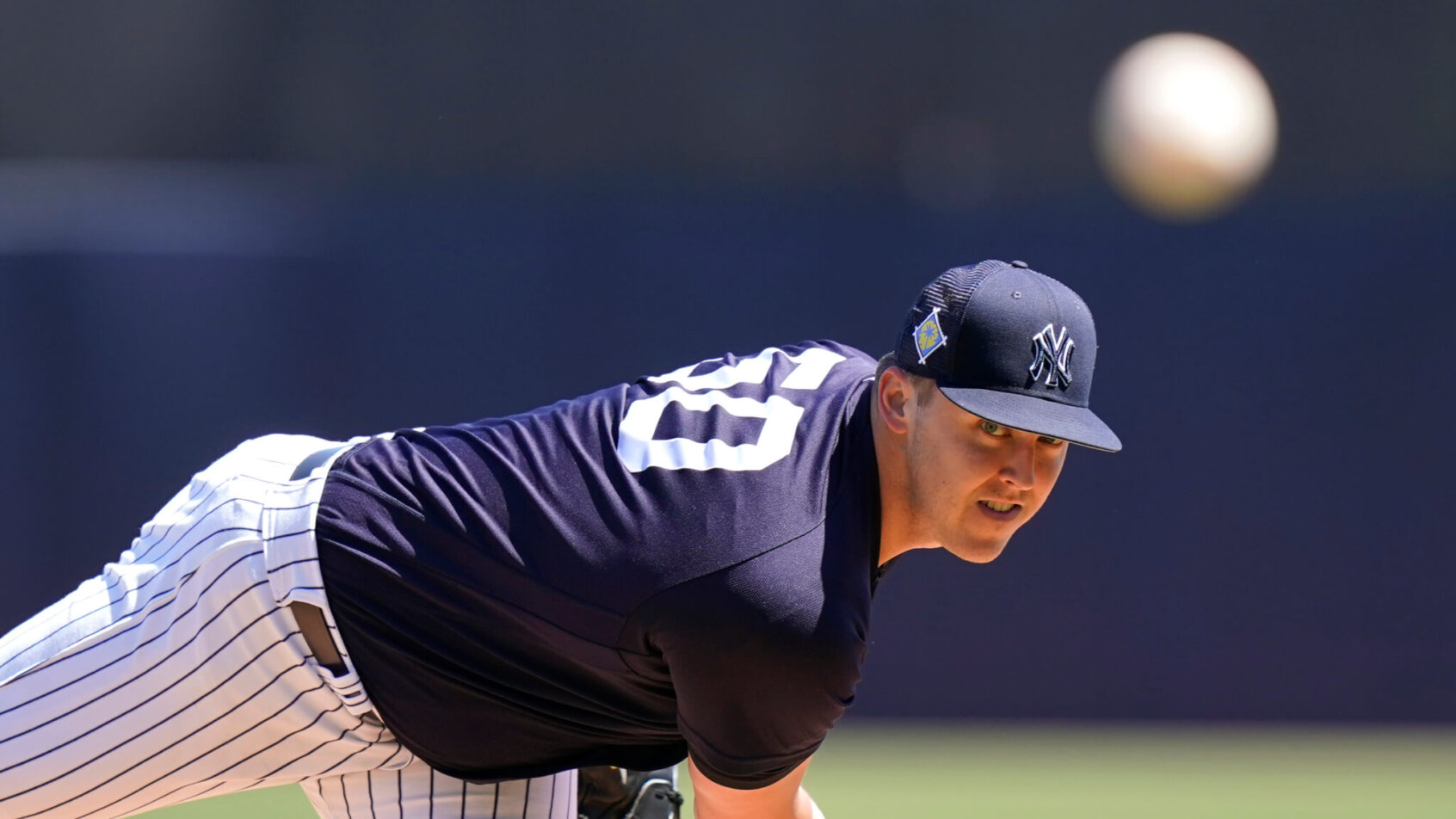 New York Yankees starting pitcher Jameson Taillon delivering a pitch to home plate