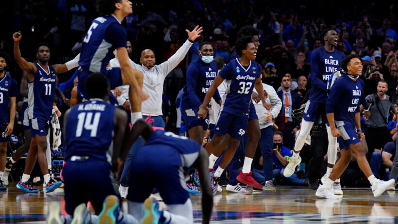 Saint Peter's players celebrating a win over Purdue