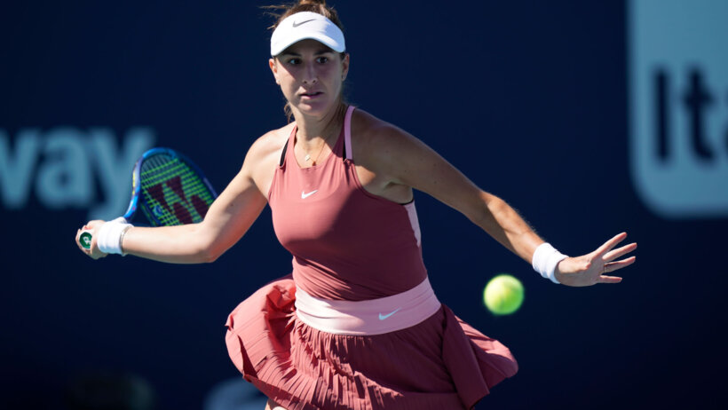 Belinda Bencic hitting a return shot during a tennis match at the Miami Open.