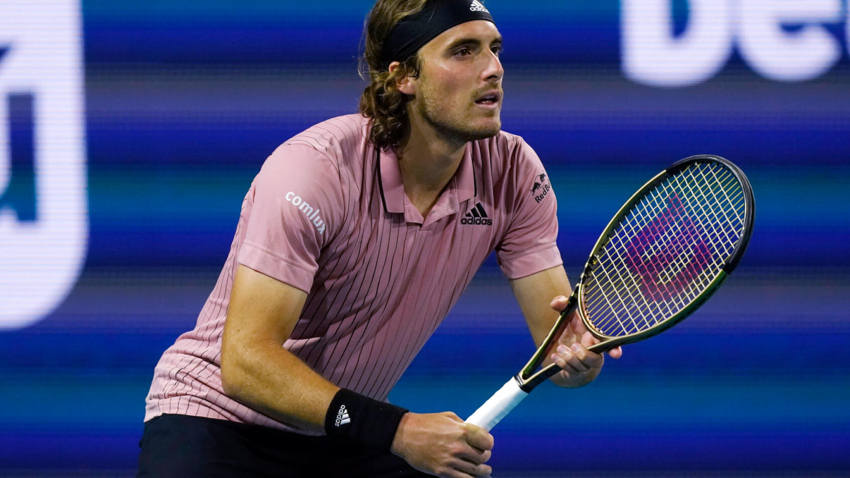 Stefanos Tsitsipas waiting for a serve during a tennis match.