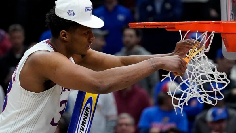Kansas' David McCormack cutting down the nets after his team advanced to the Final Four