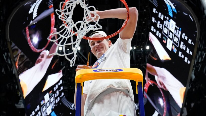 Kansas' Mitch Lightfoot cutting down the nets in March Madness 2022