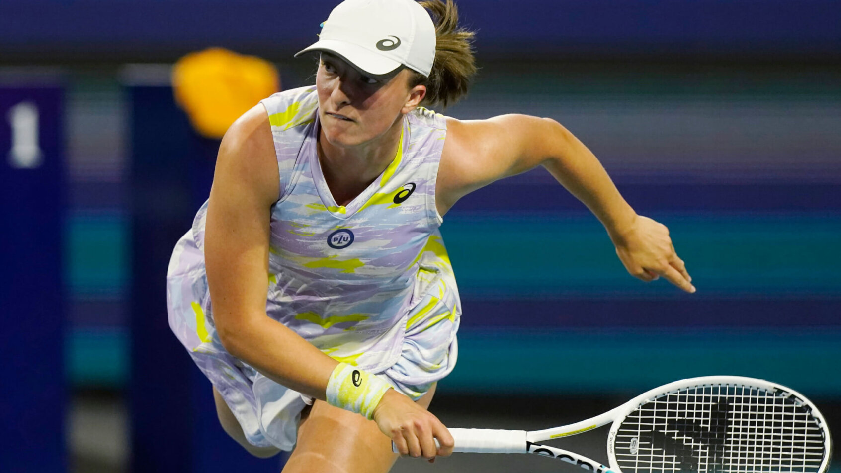 Iga Swiatek serving during a tennis match at the Miami Open.