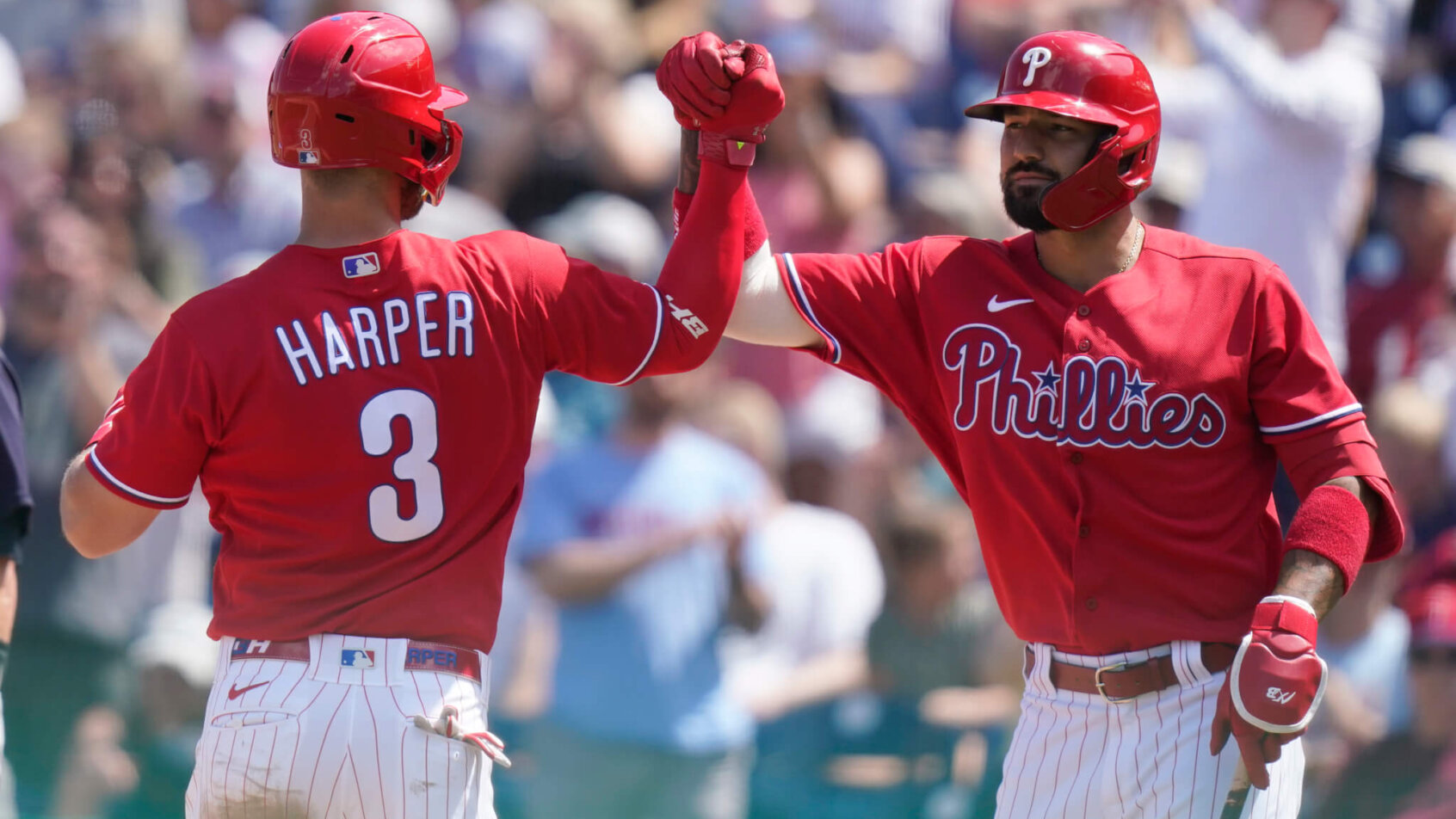 Philadelphia Phillies' Bryce Harper high-fiving Nick Castellanos