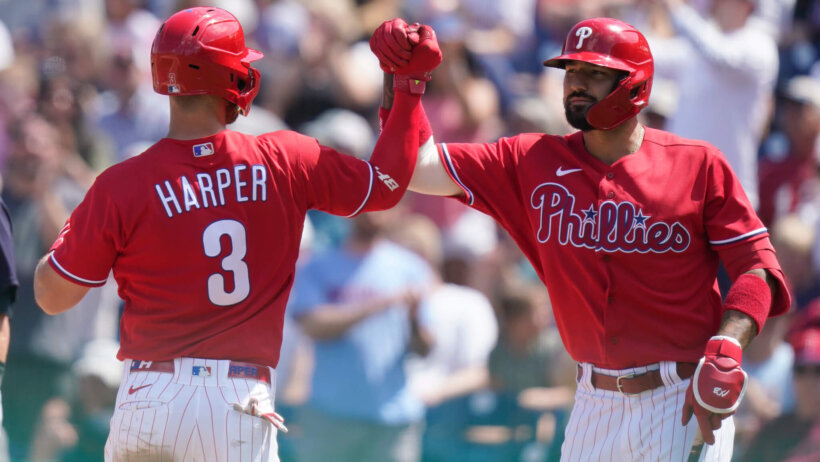 Philadelphia Phillies' Bryce Harper high-fiving Nick Castellanos