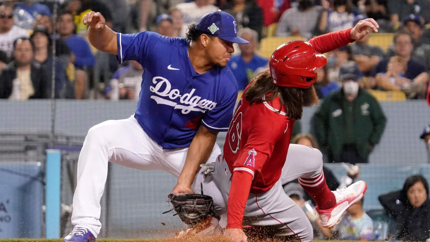 Los Angeles Dodgers relief pitcher Brusdar Graterol tags out a runner at third base