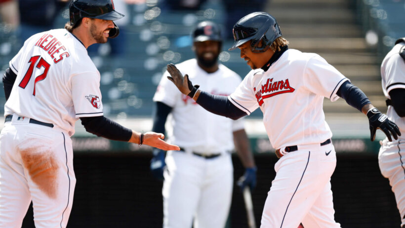 Cleveland Guardians' José Ramírez celebrates at home plate with teammate Austin Hedges
