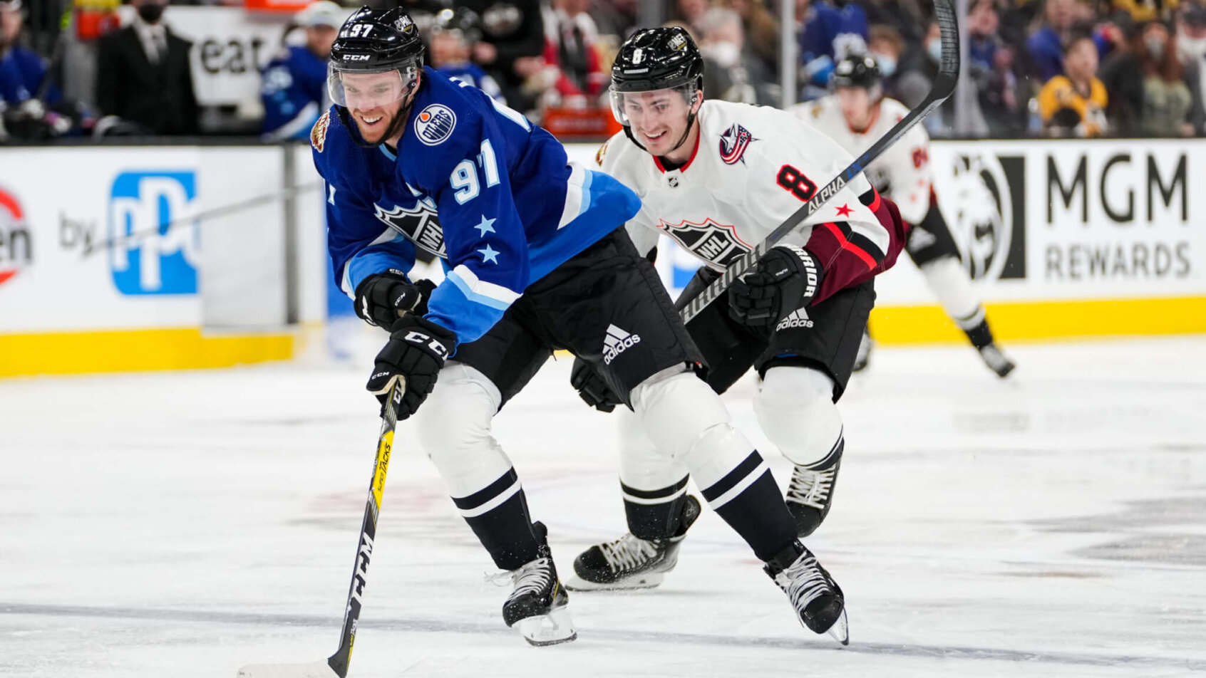 Connor McDavid skating with puck blue jersey all star game