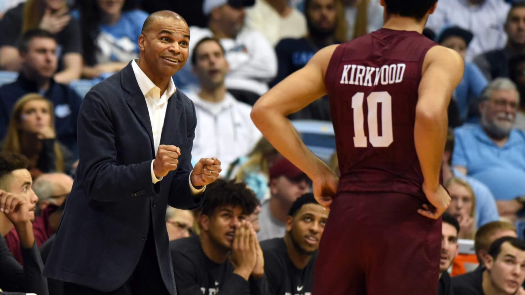 Harvard Crimson head coach Tommy Amaker speaking to guard Noah Kirkwood