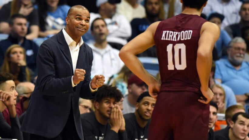 Harvard Crimson head coach Tommy Amaker speaking to guard Noah Kirkwood