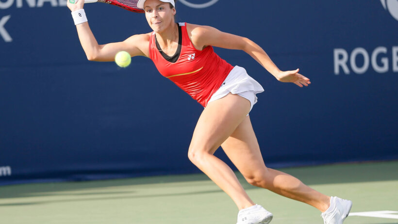 Tatjana Maria reaching for a ball during a tennis match.
