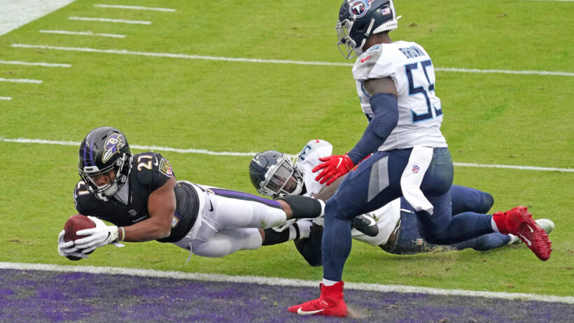 JK Dobbins diving for TD