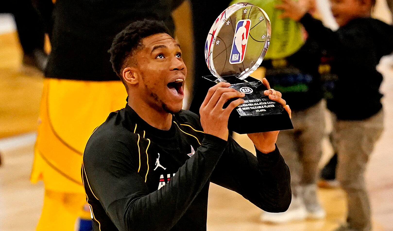 Giannis Antetokounmpo lifting the NBA All Star MVP trophy last year.