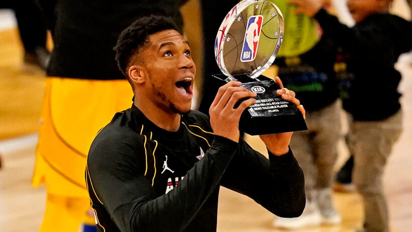 Giannis Antetokounmpo lifting the NBA All Star MVP trophy last year.