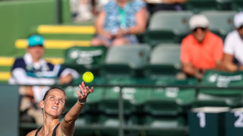 Karolina Pliskova throwing up a ball for a serve during a match.
