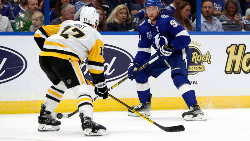 Tampa Bay Lightning center Steven Stamkos skates with the puck against Pittsburgh Penguins right wing Bryan Rust