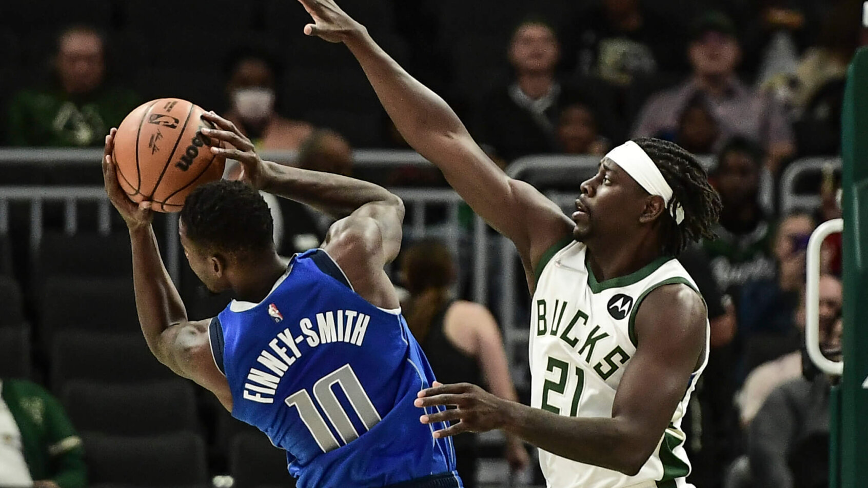 Jrue Holiday attempts to block a shot