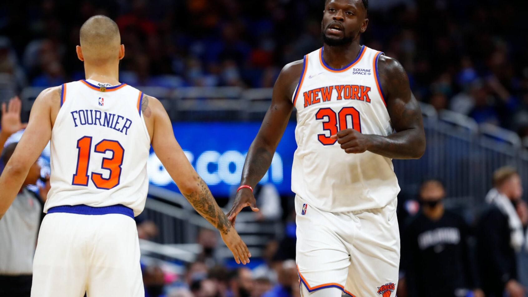 Evan Fournier and Julius Randle give each other five