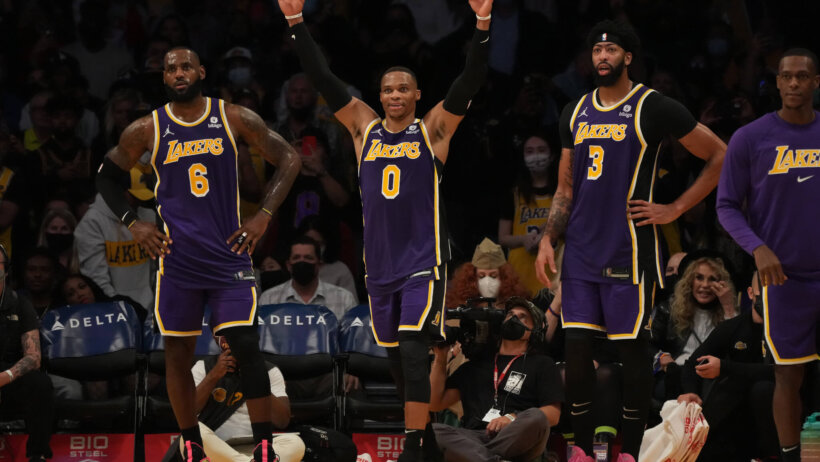 LeBronJames, Russell Westbrook and Anthony Davis standing on sidelines