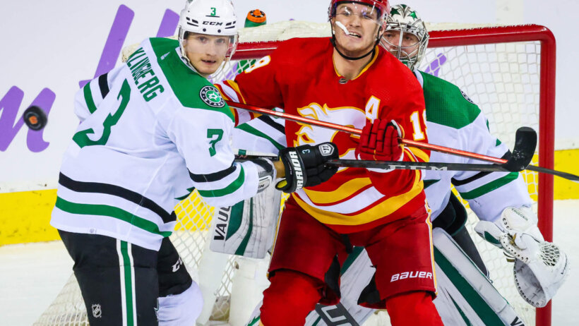 Dallas Stars defenseman John Klingberg and Calgary Flames left wing Matthew Tkachuk fight for position in front of the net