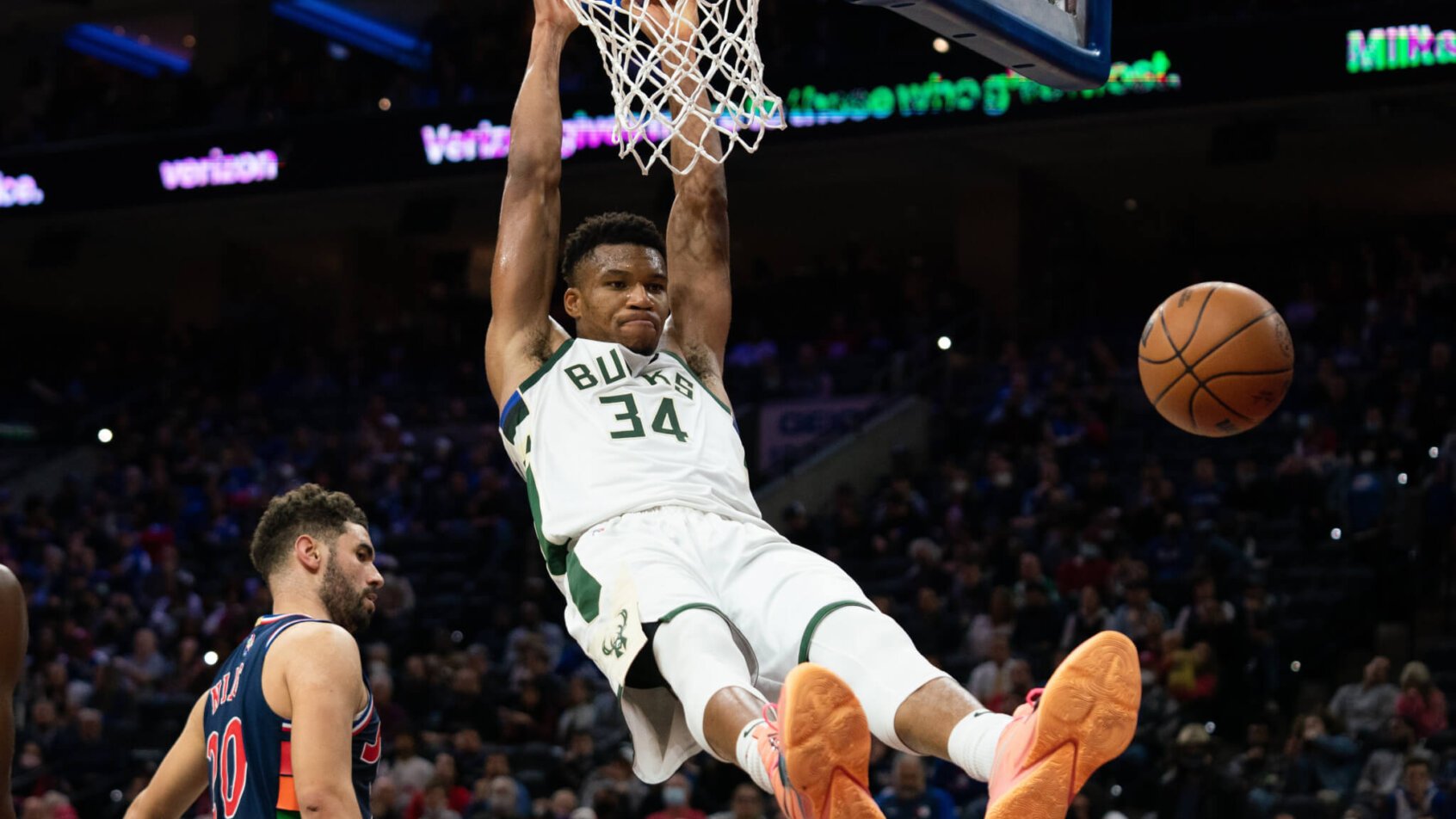 Giannis Antetokounmpo hanging on rim after dunking