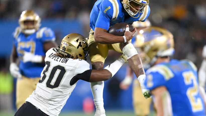 UCLA Bruins quarterback Dorian Thompson-Robinson runs the football