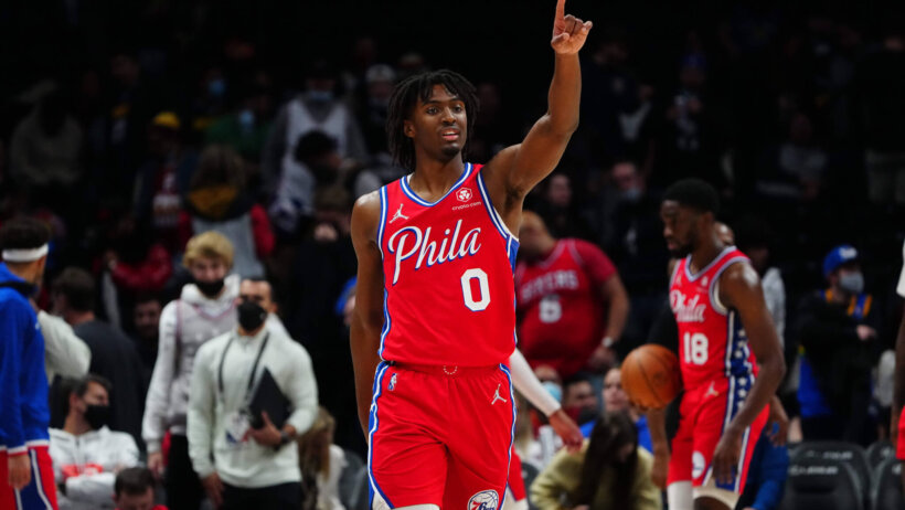 Tyrese Maxey pointing and looking into crowd