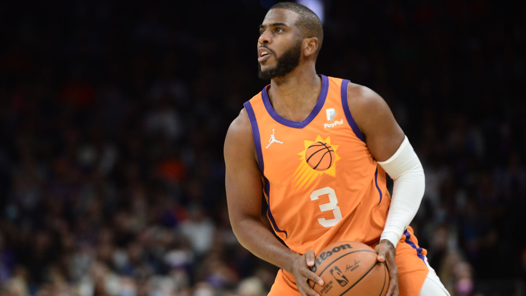 Chris Paul holding basketball, preparing to shoot