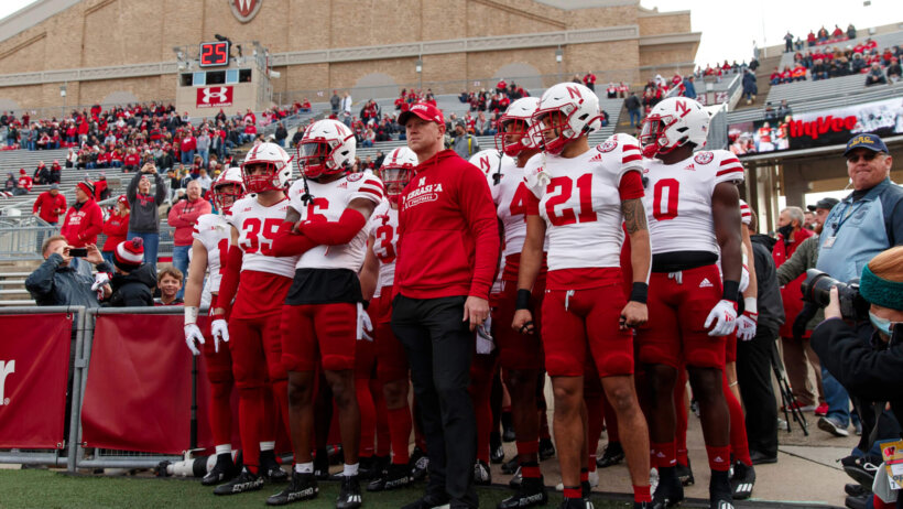 Scott Frost leads Nebraska onto the field