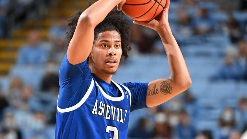 North Carolina-Asheville Bulldogs guard Tajion Jones looks to make a pass