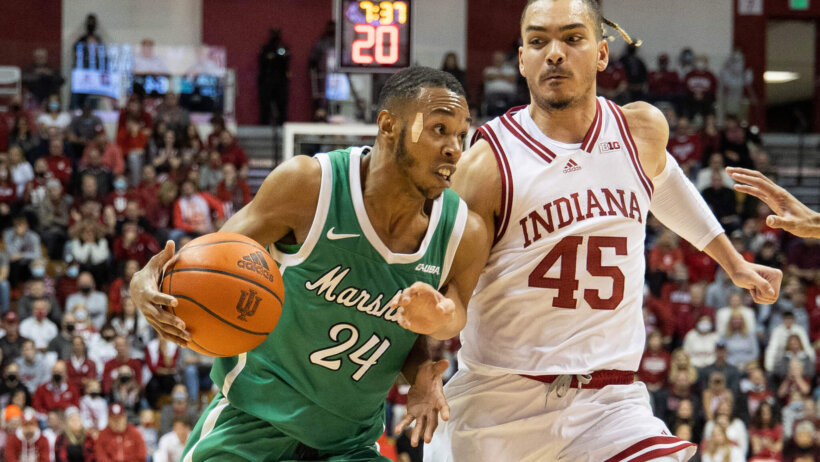 Marshall Thundering Herd guard Taevion Kinsey drives around a defender