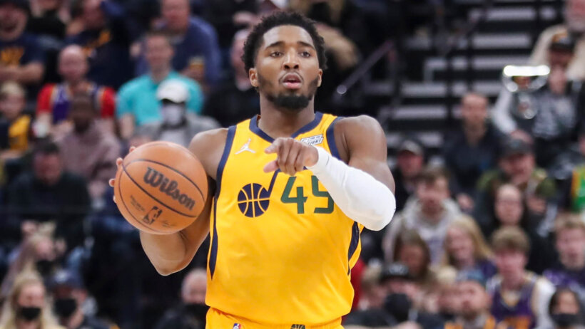 Donovan Mitchell dribbling ball and pointing