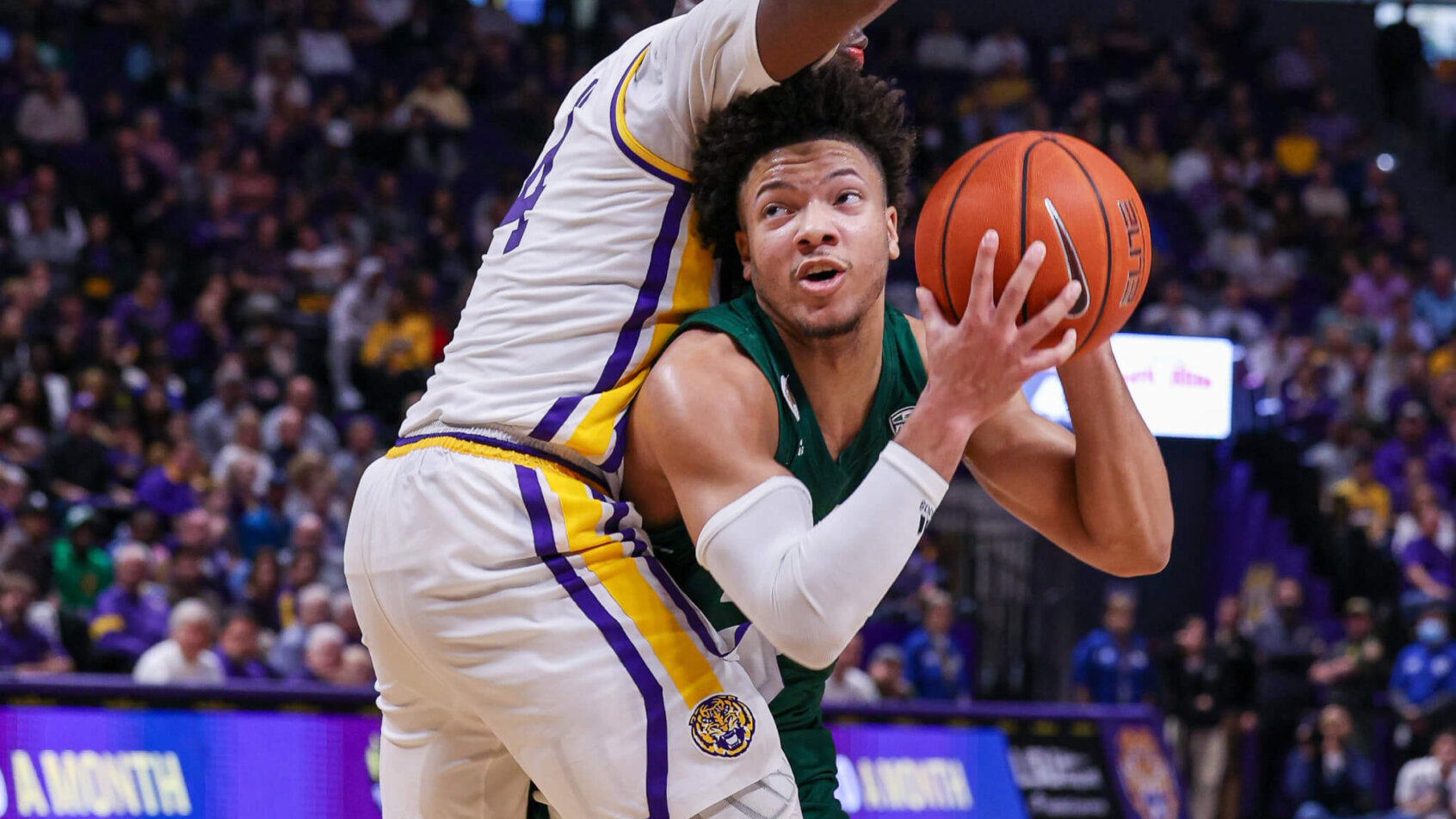 Bobcats guard Mark Sears ducking under a defender