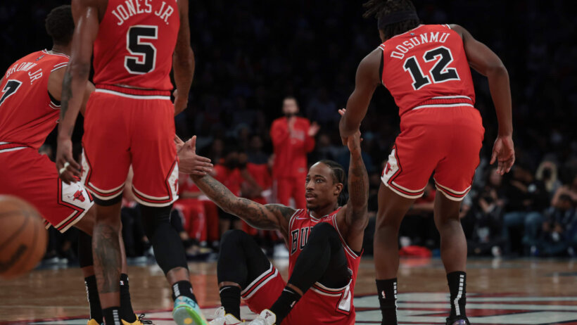 DeMar DeRozan helped off the floor by teammates