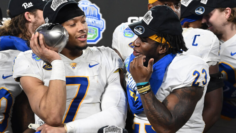 Pittsburgh Panthers linebacker SirVocea Dennis and running back Todd Sibley Jr. with the championship trophy