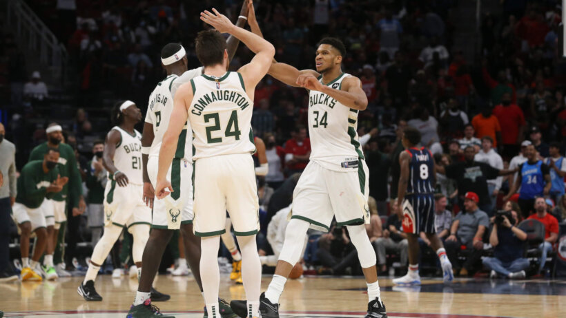 Giannis Antetokounmpo high fives teammates