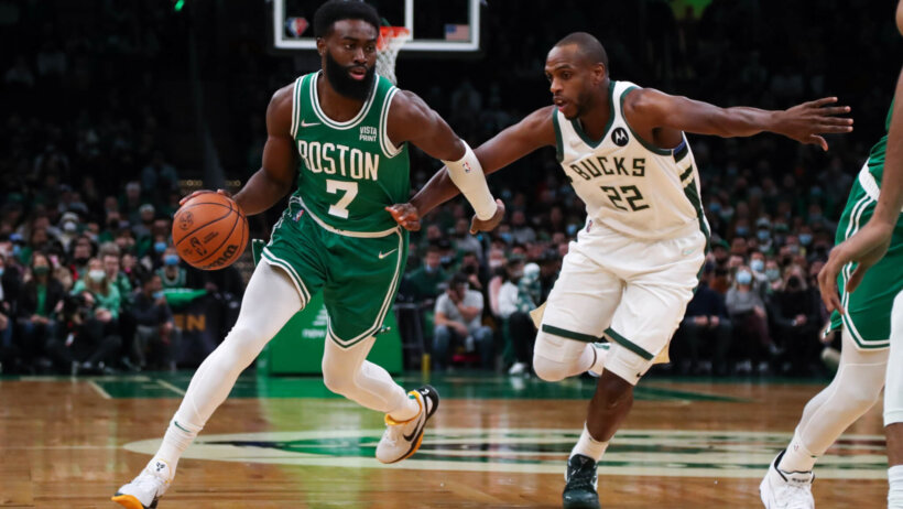 Jaylen Brown dribbling against defender