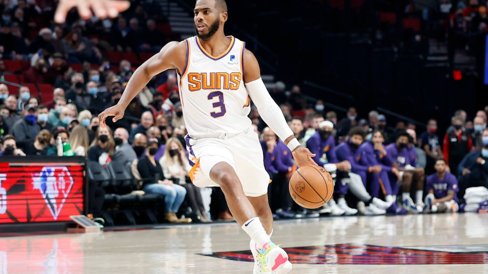 Chris Paul looking to pass the ball during an NBA game.