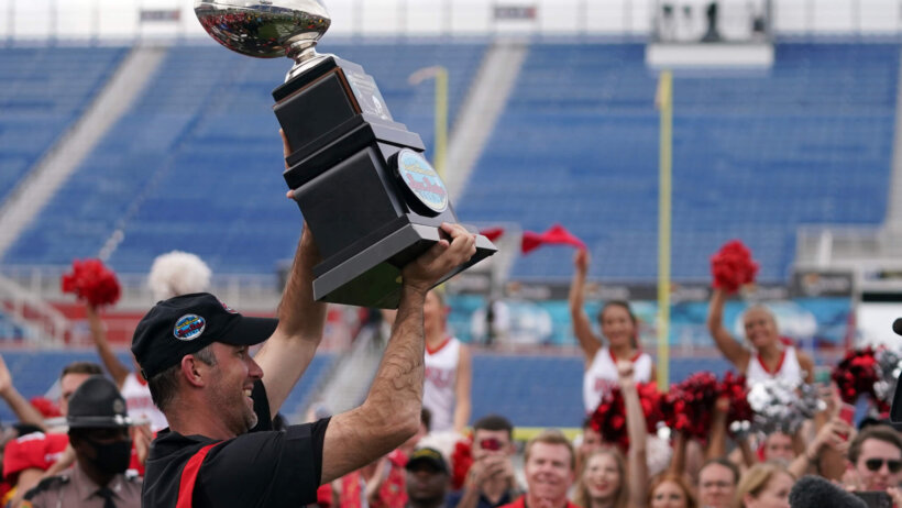 Western Kentucky Hilltoppers head coach Tyson Helton celebrates with the trophy